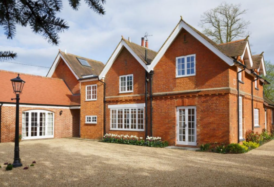 Large brick country house with driveway